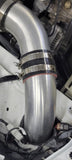black silicone hose coupler installed on a silver intake pipe with heavy-duty T-bolt clamps in an engine bay